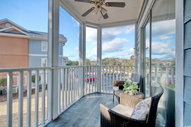 sunroom / solarium featuring ceiling fan