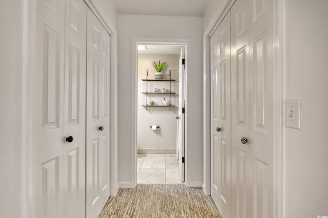 corridor with light tile patterned floors