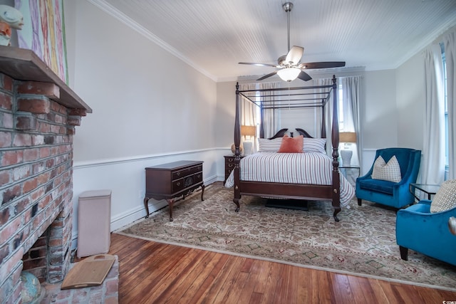 bedroom with ceiling fan, hardwood / wood-style floors, and crown molding