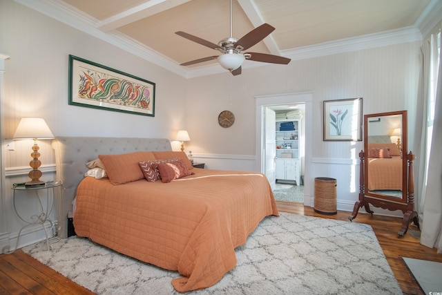 bedroom with ceiling fan, wood-type flooring, and ornamental molding