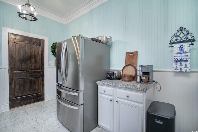 kitchen featuring a notable chandelier, stainless steel refrigerator with ice dispenser, white cabinetry, ornamental molding, and light stone counters