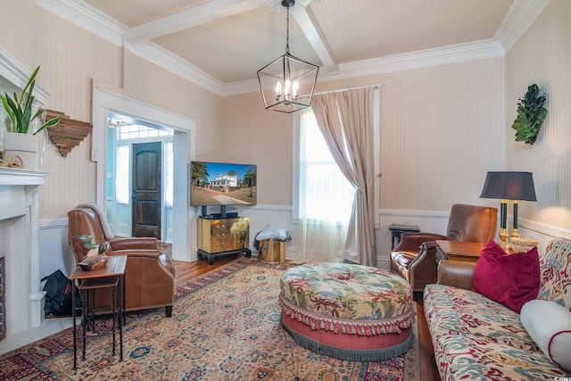 living room with hardwood / wood-style flooring, ornamental molding, beam ceiling, and an inviting chandelier