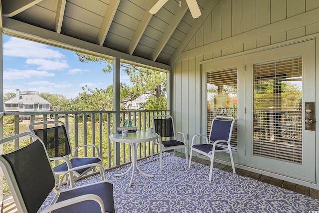 sunroom / solarium with ceiling fan, lofted ceiling with beams, and wooden ceiling