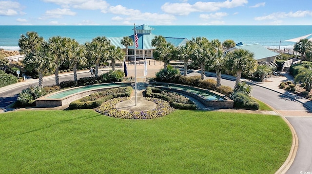 view of home's community with a yard and a water view