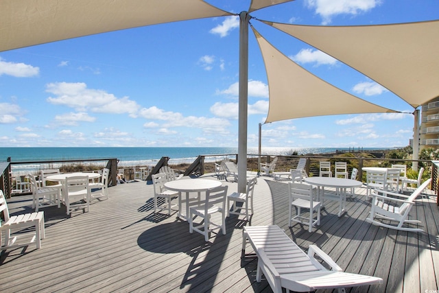 deck with a view of the beach and a water view