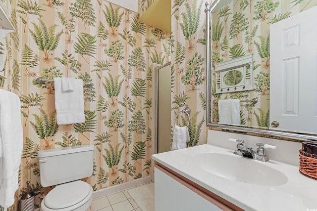 bathroom featuring tile patterned flooring, vanity, and toilet