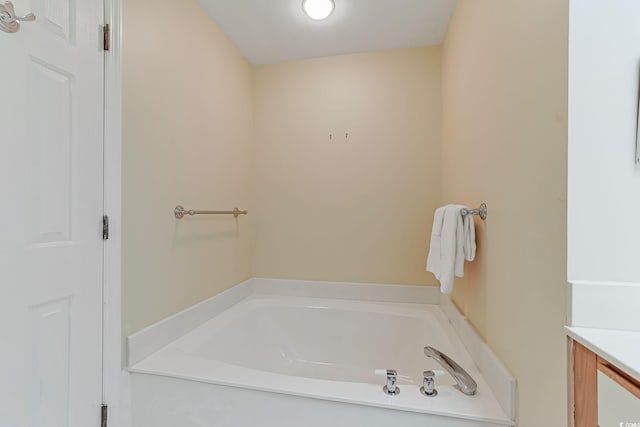 bathroom with vanity and a tub to relax in