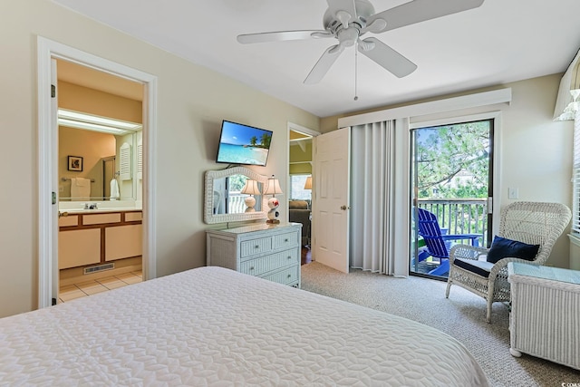 carpeted bedroom with access to outside, connected bathroom, and ceiling fan