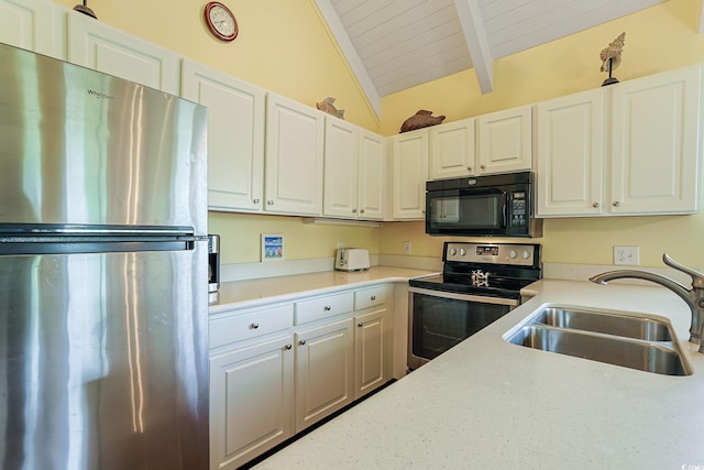 kitchen with wood ceiling, stainless steel appliances, sink, lofted ceiling with beams, and white cabinetry