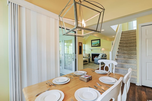 dining room with dark hardwood / wood-style floors, an inviting chandelier, and plenty of natural light