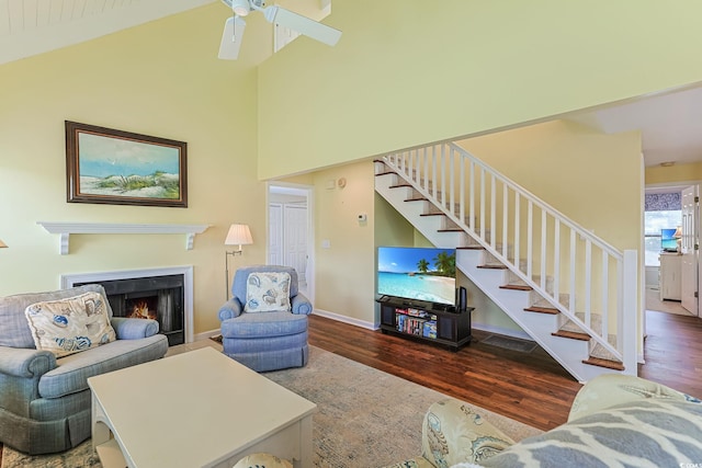 living room featuring wood-type flooring, vaulted ceiling, and ceiling fan