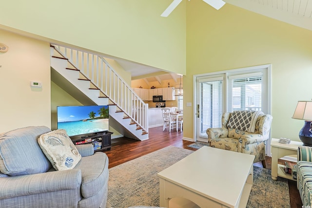 living room featuring ceiling fan, dark wood-type flooring, and high vaulted ceiling