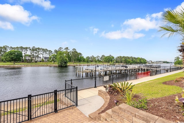 dock area featuring fence and a water view