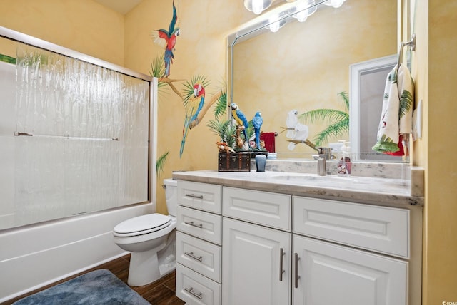 bathroom with shower / bath combination with glass door, toilet, vanity, and wood finished floors