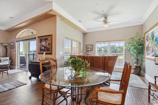 dining room featuring visible vents, plenty of natural light, baseboards, and wood finished floors