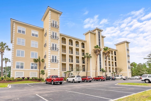 view of building exterior with uncovered parking