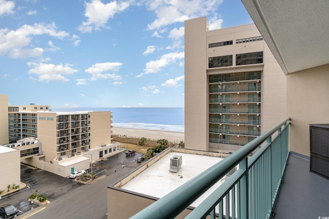 balcony featuring a water view and a view of the beach