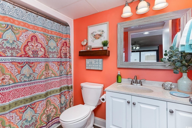 bathroom with vanity, ceiling fan, toilet, and walk in shower