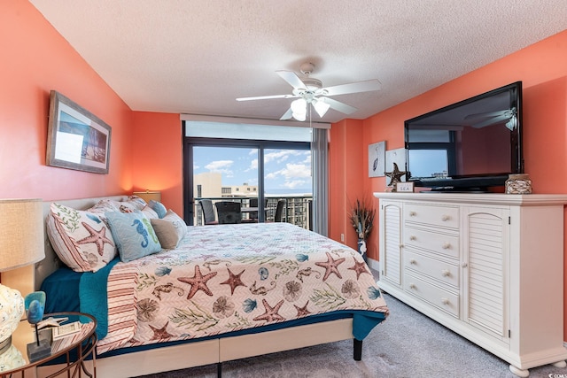 bedroom featuring carpet, ceiling fan, a textured ceiling, and access to outside