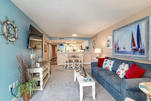 carpeted living room featuring a textured ceiling