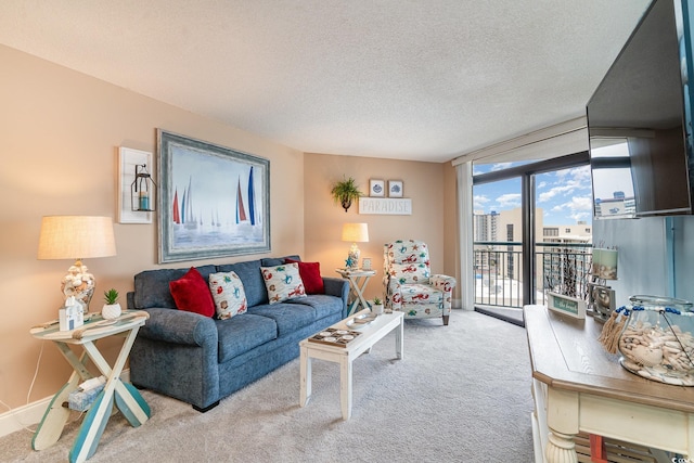 living room with floor to ceiling windows, light carpet, and a textured ceiling