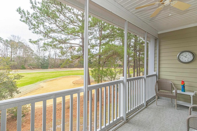 unfurnished sunroom with ceiling fan