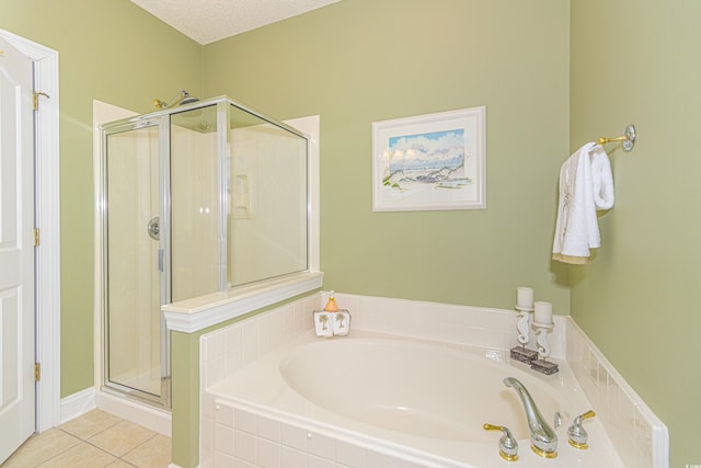 bathroom with tile patterned floors, plus walk in shower, and a textured ceiling