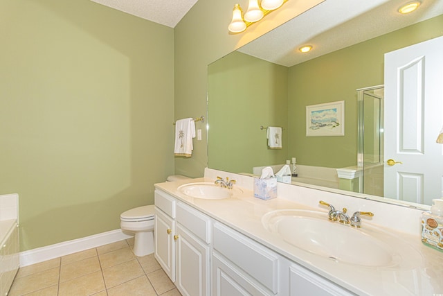 full bathroom with tile patterned flooring, separate shower and tub, a textured ceiling, toilet, and vanity