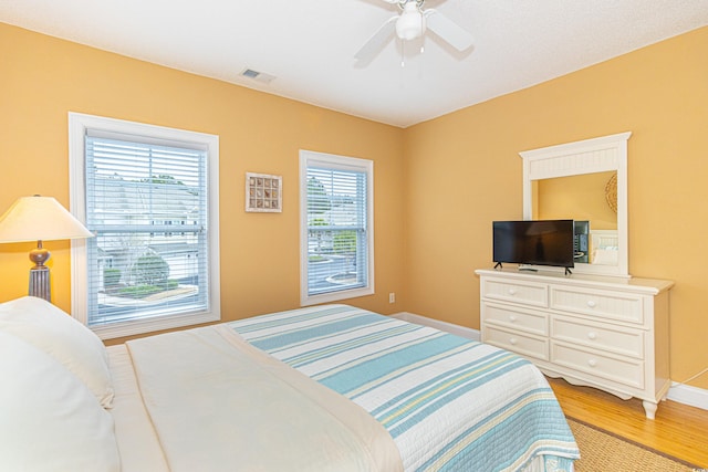 bedroom with ceiling fan and light hardwood / wood-style floors