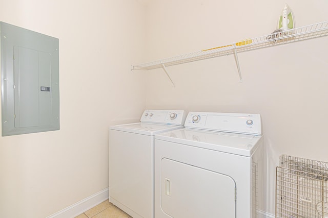 laundry area featuring light tile patterned flooring, independent washer and dryer, and electric panel