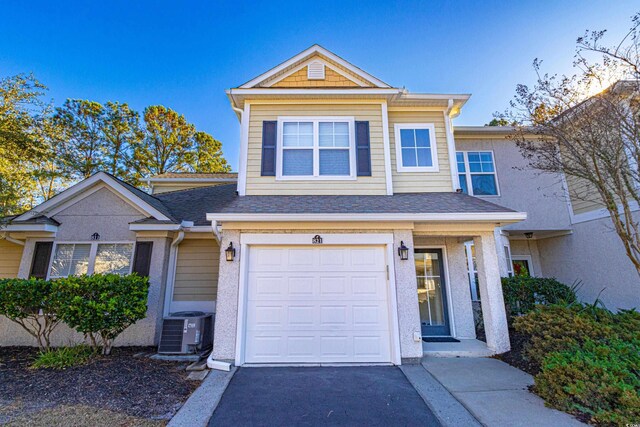 view of front of property with central AC and a garage