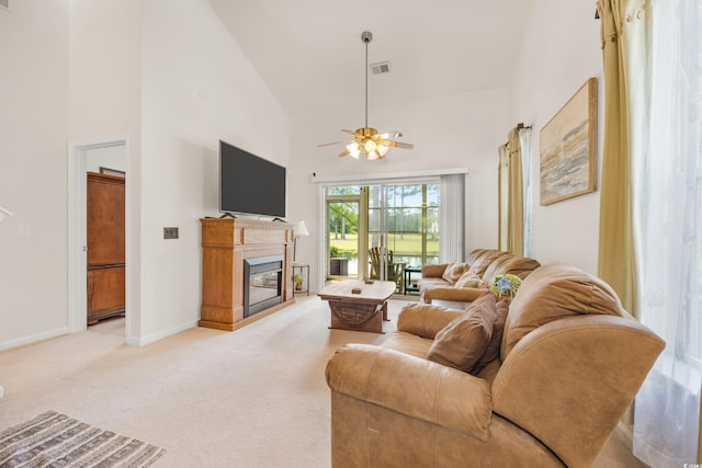 carpeted living room featuring ceiling fan and high vaulted ceiling