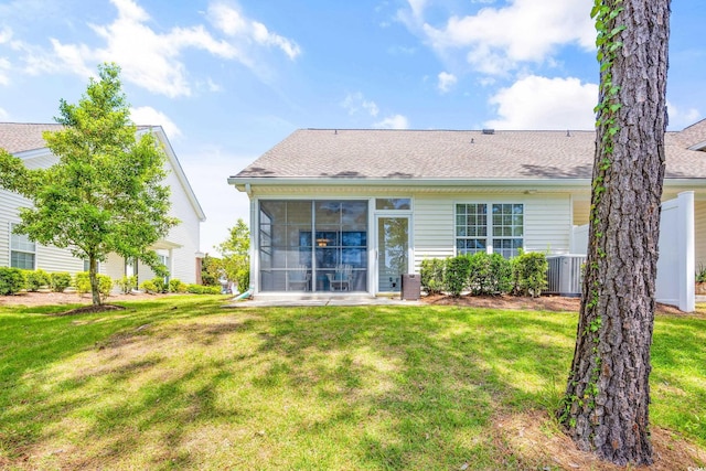 back of house with a yard and central AC