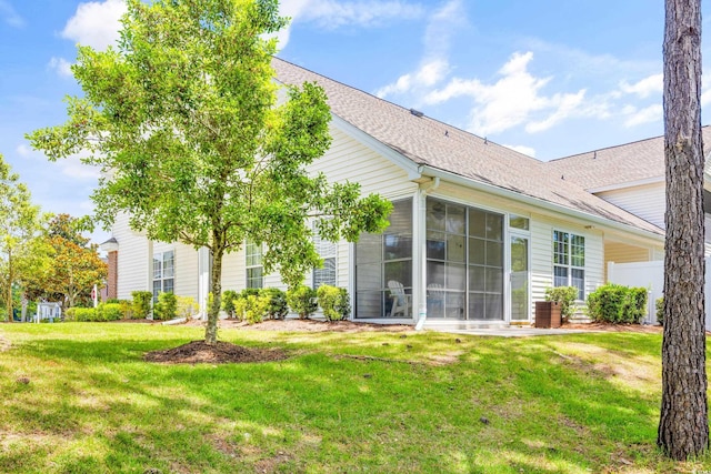 rear view of house with a yard