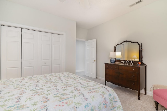 carpeted bedroom with ceiling fan and a closet