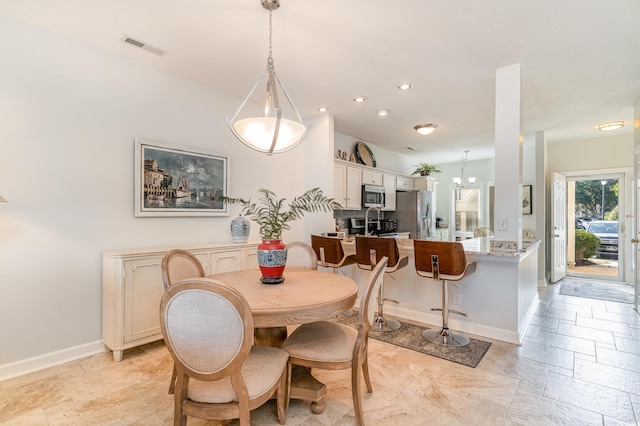 dining space featuring an inviting chandelier