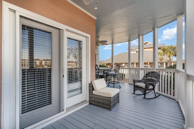 sunroom / solarium featuring ceiling fan