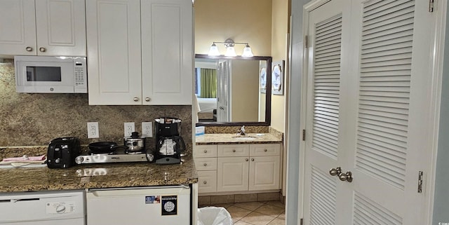 241 Presidential Dr, Surfside Beach, SC 29575 - kitchen with white appliances, a sink, white cabinetry, tasteful backsplash, and light tile patterned floors