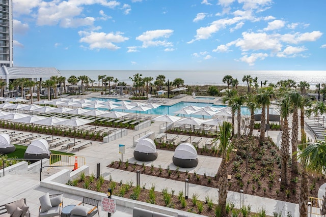 view of swimming pool featuring a water view