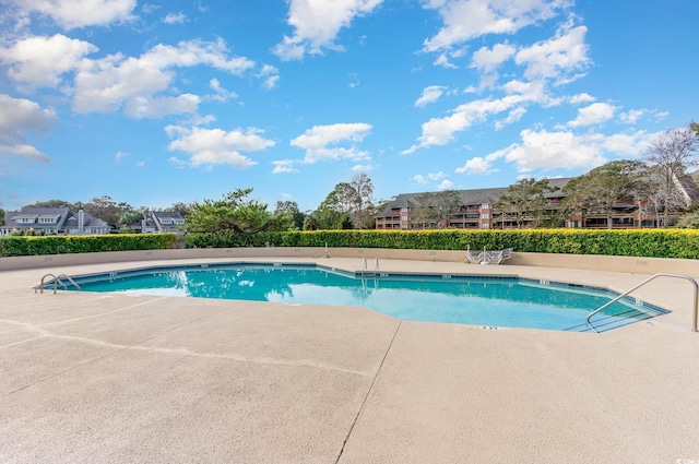 view of swimming pool with a patio area