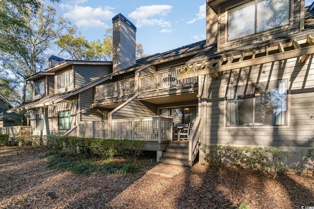 back of house with a wooden deck