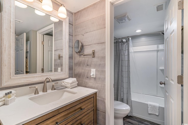 full bathroom featuring vanity, toilet, shower / bath combo with shower curtain, and wood-type flooring