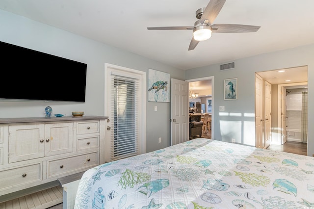 bedroom with ceiling fan, hardwood / wood-style floors, and ensuite bathroom