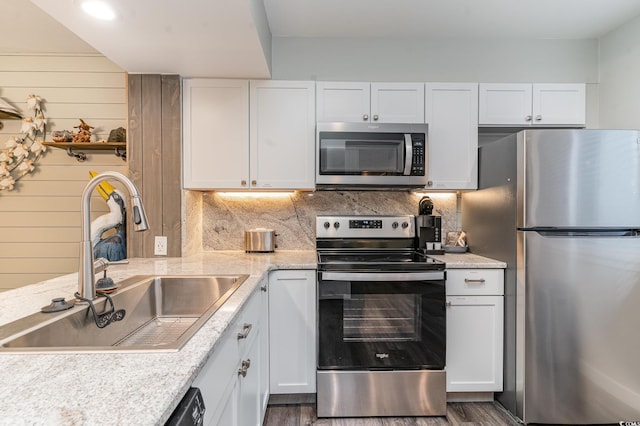 kitchen with white cabinets, dark hardwood / wood-style flooring, stainless steel appliances, and sink