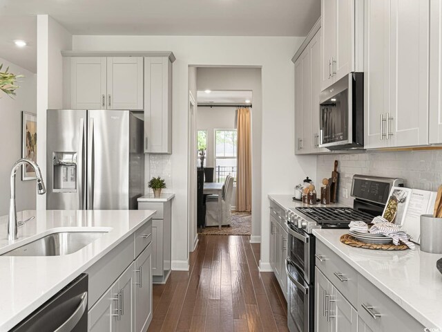 5032 Riverton Ct, Myrtle Beach, SC 29579 - kitchen featuring dark hardwood / wood-style flooring, stainless steel appliances, sink, backsplash, and gray cabinetry