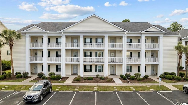 view of building exterior featuring uncovered parking