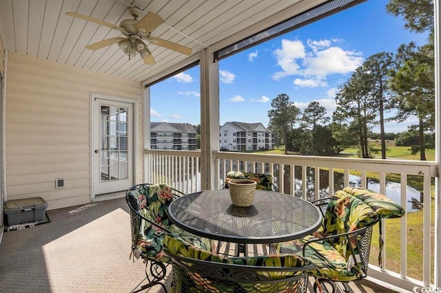 sunroom / solarium with ceiling fan and wooden ceiling