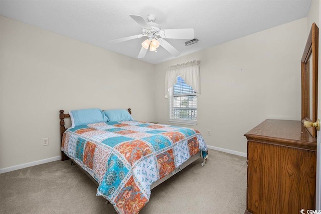 carpeted bedroom with ceiling fan, visible vents, and baseboards