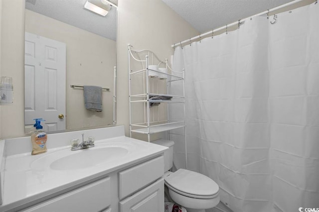 bathroom featuring a textured ceiling, toilet, a shower with shower curtain, and vanity