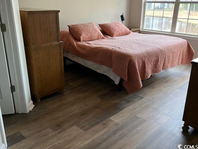 bedroom with dark wood finished floors